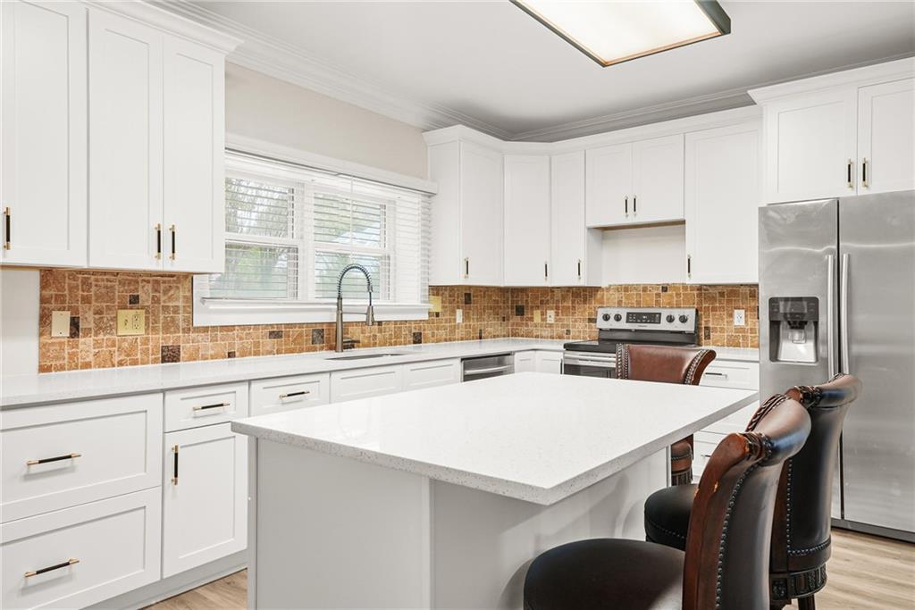 7445 Talbot Colony Northeast Atlanta, GA 30328 - Photo 14 of 41 a kitchen with white cabinets and stainless steel appliances