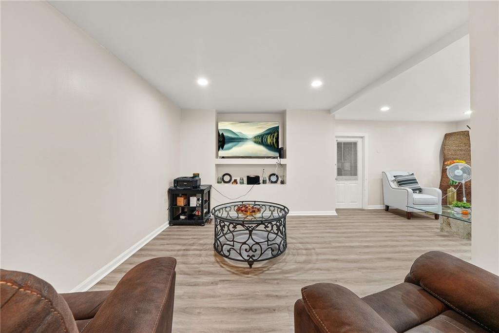 7445 Talbot Colony Northeast Atlanta, GA 30328 - Photo 17 of 41 a living room with furniture and a flat screen tv