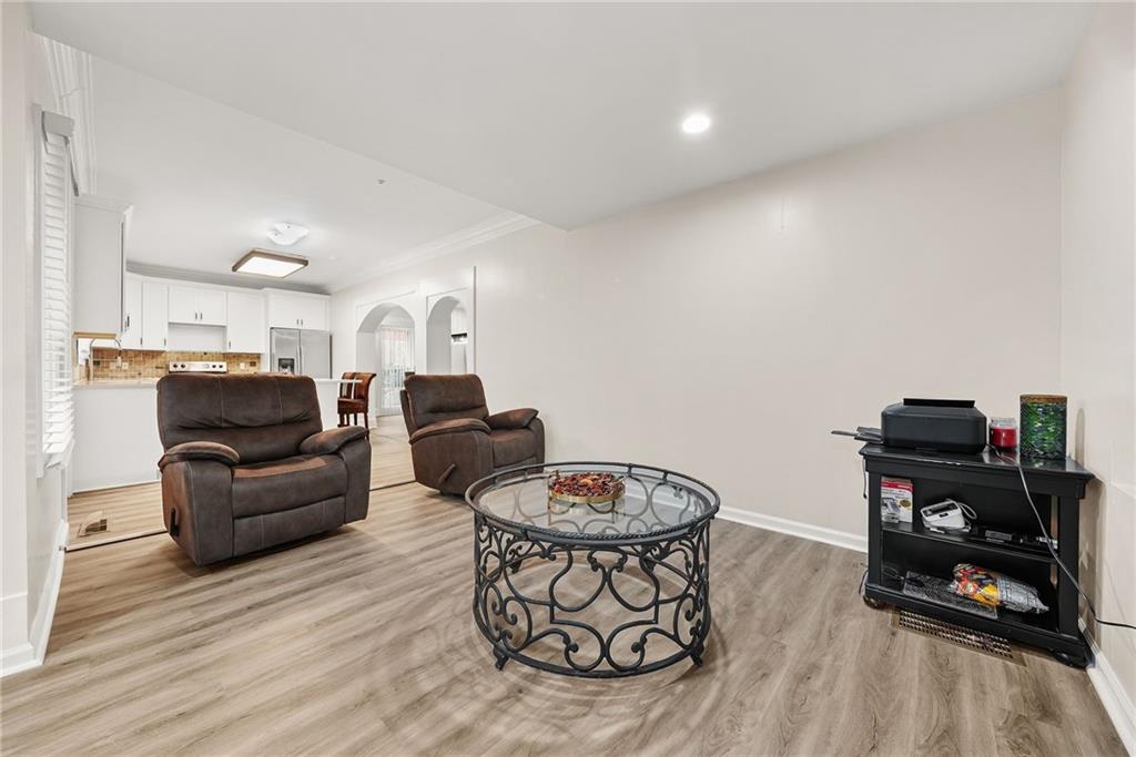 7445 Talbot Colony Northeast Atlanta, GA 30328 - Photo 18 of 41 a living room with furniture and a wooden floor