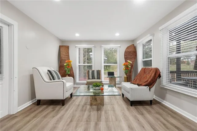 a living room with furniture and floor to ceiling windows