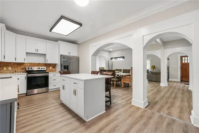 a kitchen with stainless steel appliances granite countertop a stove and cabinets