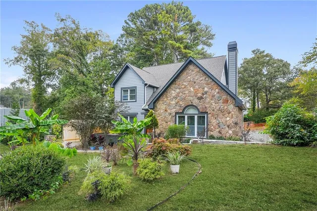 a front view of house with a garden