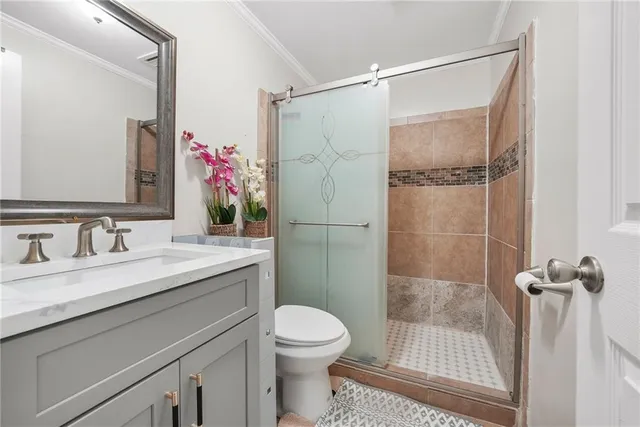 a bathroom with a granite countertop sink toilet and shower