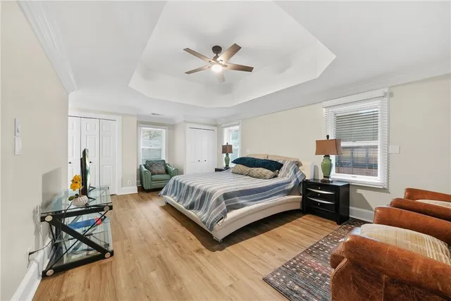 a spacious bedroom with a bed and wooden floor