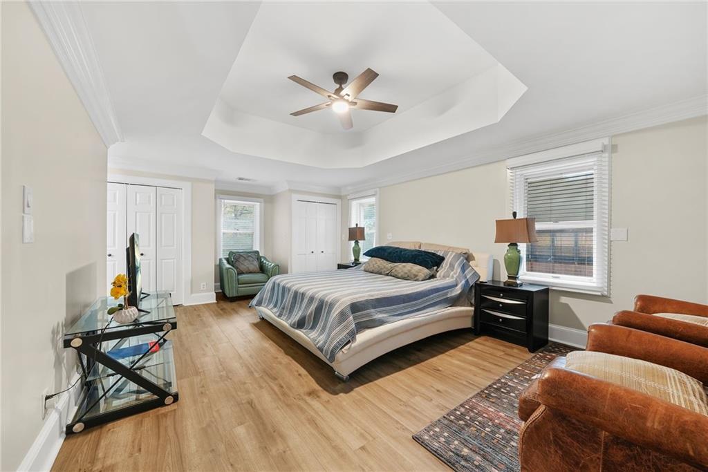 7445 Talbot Colony Northeast Atlanta, GA 30328 - Photo 24 of 41 a spacious bedroom with a bed and wooden floor
