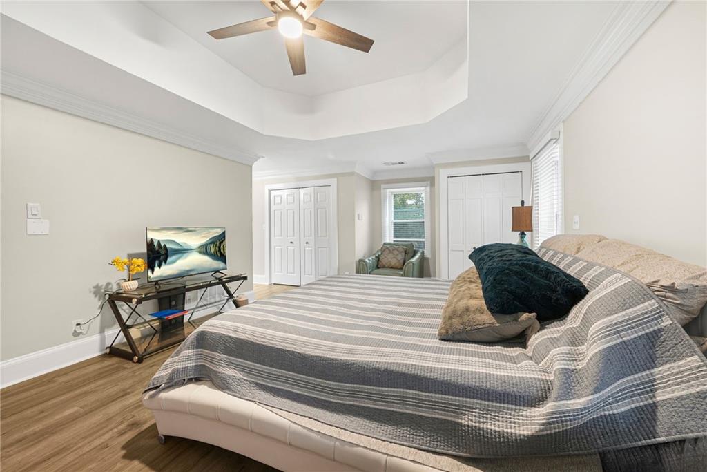 7445 Talbot Colony Northeast Atlanta, GA 30328 - Photo 25 of 41 a bedroom with a bed and wooden floor