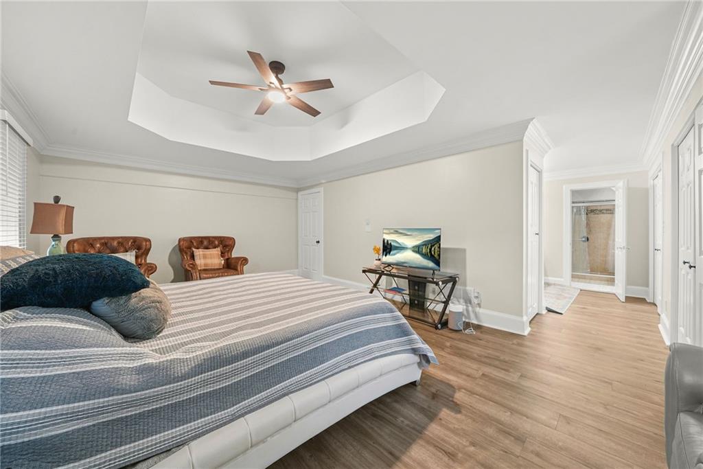 7445 Talbot Colony Northeast Atlanta, GA 30328 - Photo 26 of 41 a bedroom with a bed and a chandelier