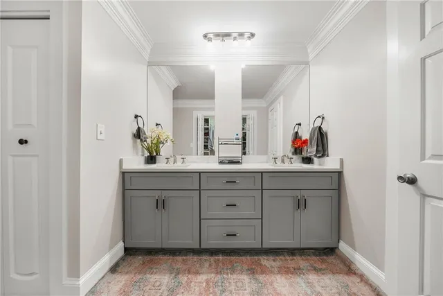 a spacious bathroom with a double vanity sink and a mirror