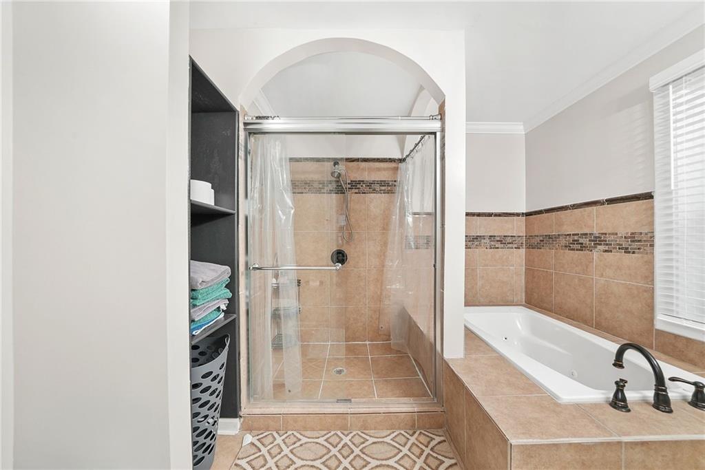 7445 Talbot Colony Northeast Atlanta, GA 30328 - Photo 30 of 41 a bathroom with a tub and shower