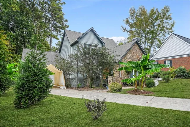 a front view of house with a garden