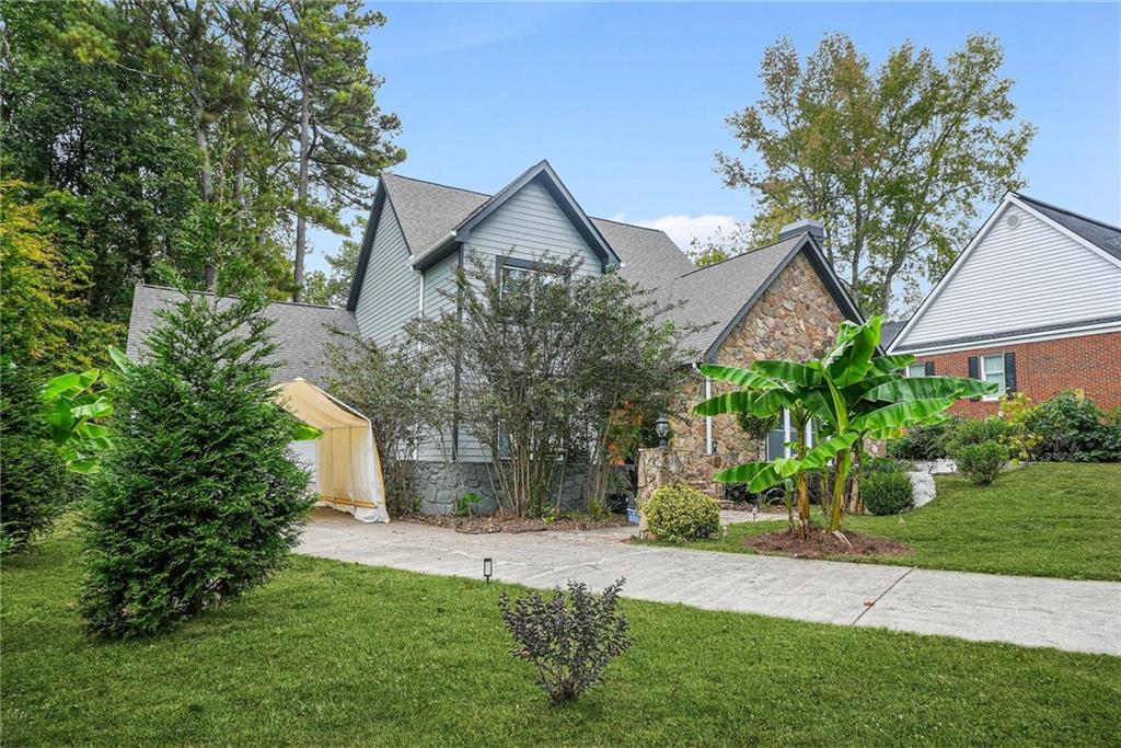 7445 Talbot Colony Northeast Atlanta, GA 30328 - Photo 3 of 41 a front view of house with a garden