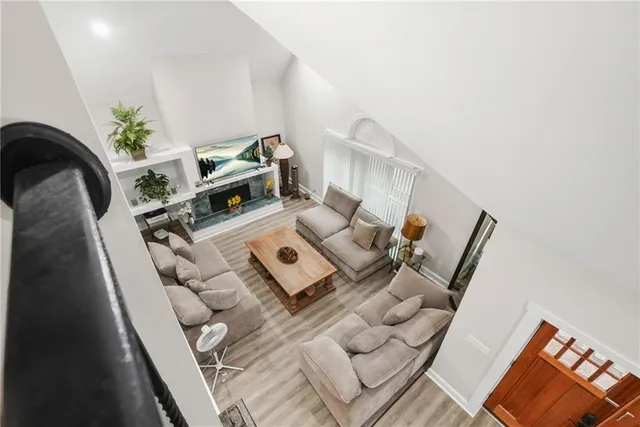 a living room with furniture and floor to ceiling window