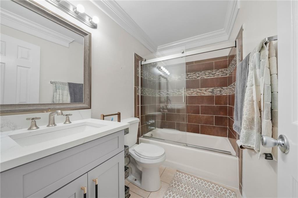 7445 Talbot Colony Northeast Atlanta, GA 30328 - Photo 33 of 41 a bathroom with a shower sink vanity mirror and toilet