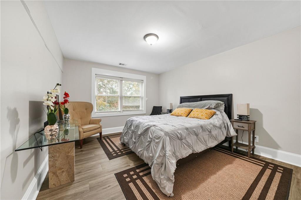 7445 Talbot Colony Northeast Atlanta, GA 30328 - Photo 34 of 41 a bedroom with a bed and wooden floor
