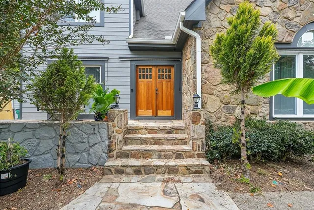 a front view of a house with potted plants