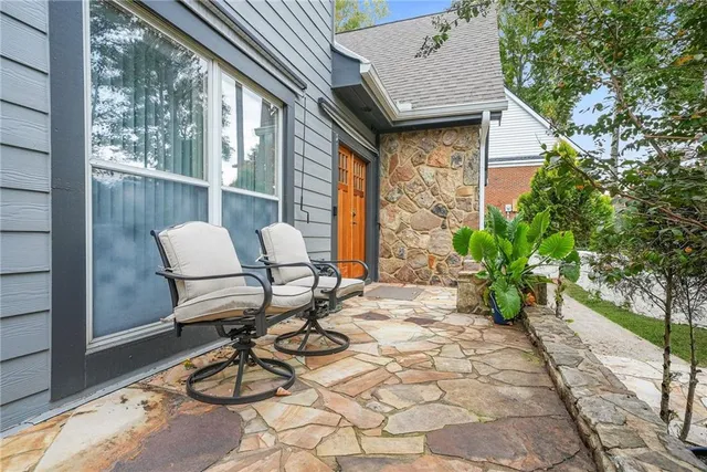a view of a patio with table and chairs and potted plants