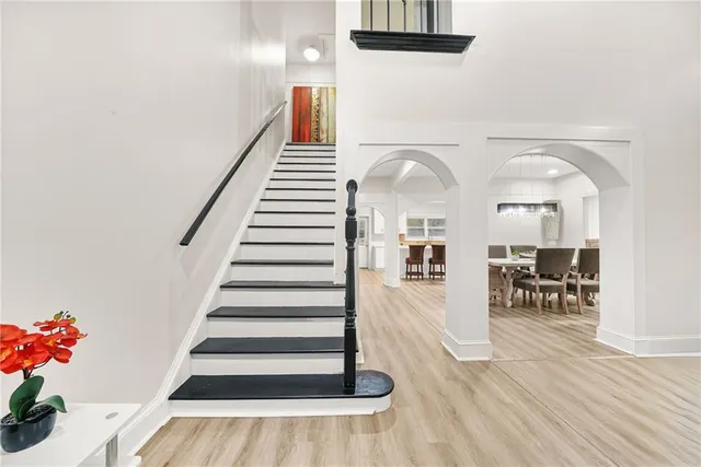 a view of entryway and hall with wooden floor