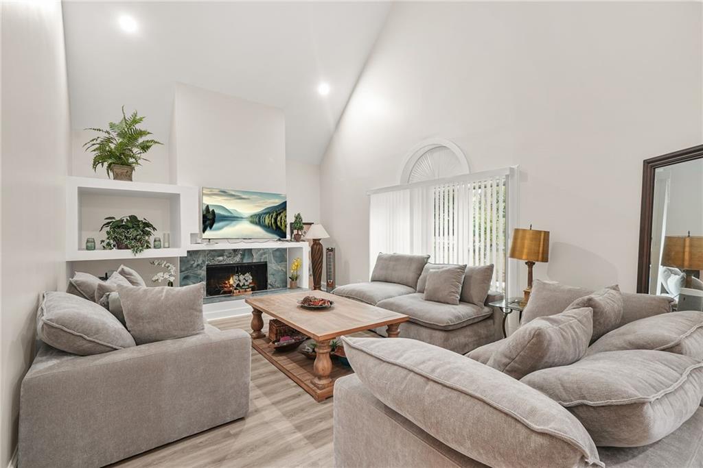 7445 Talbot Colony Northeast Atlanta, GA 30328 - Photo 8 of 41 a living room with furniture and a fireplace