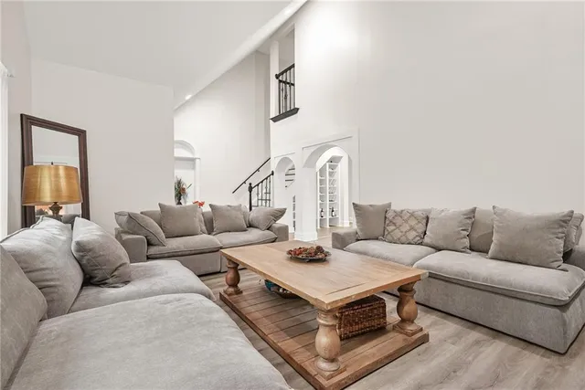 a living room with furniture a rug and a chandelier