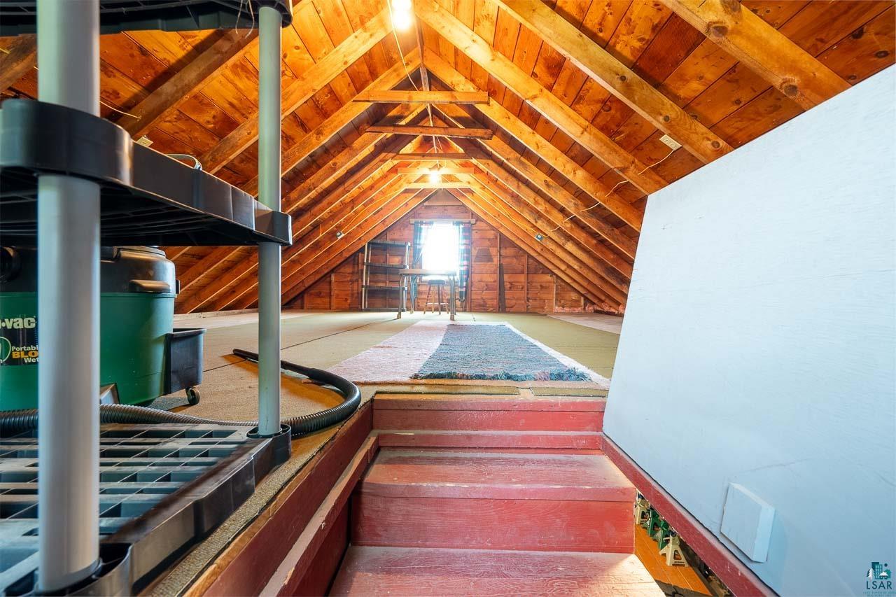 101 2nd Avenue North Biwabik, MN 55708 - Photo 34 of 44 Spacious attic area featuring exposed wood beam ceilings and a window