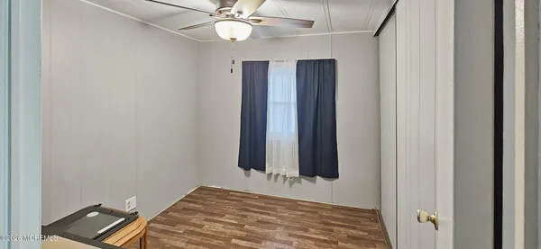 a view of room with window and ceiling fan