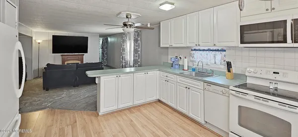a kitchen with stainless steel appliances granite countertop a sink and a stove top oven
