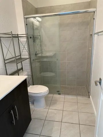 a bathroom with a toilet a sink and shower