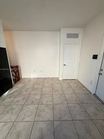 a view of a livingroom and an empty room