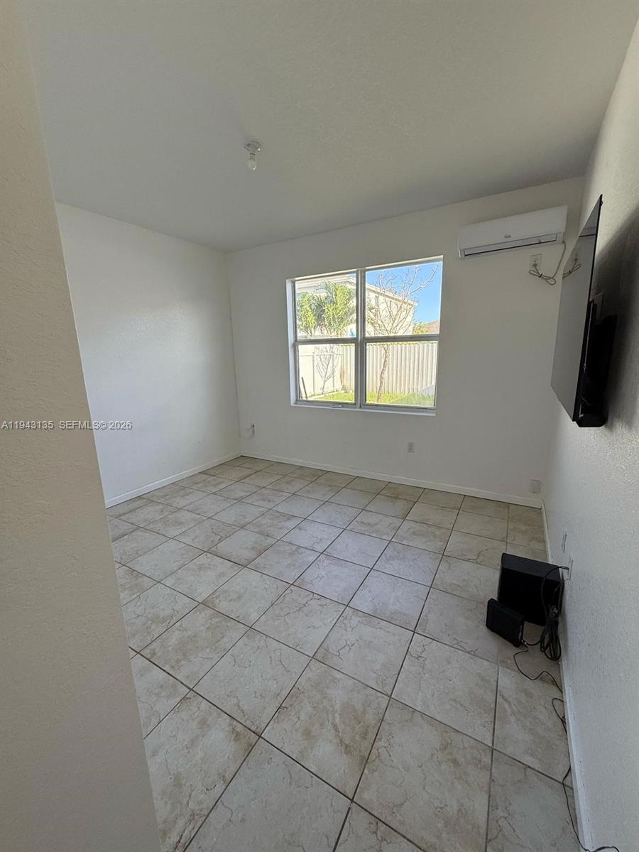 13280 Southwest 272nd Street, Unit 1 Homestead, FL 33032 - Photo 6 of 7 a view of an empty room with a window