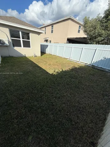 a view of a backyard of the house