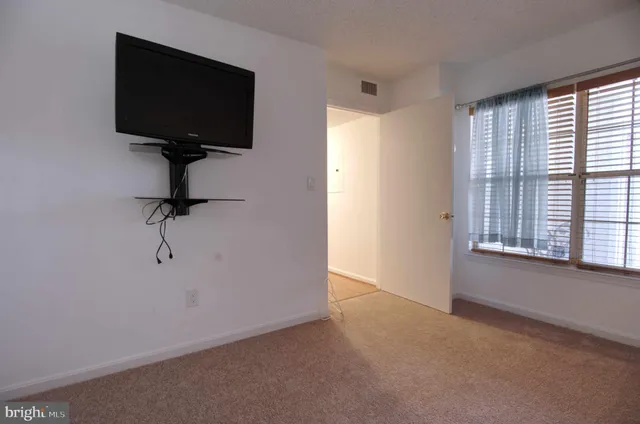a living room with projector and a window