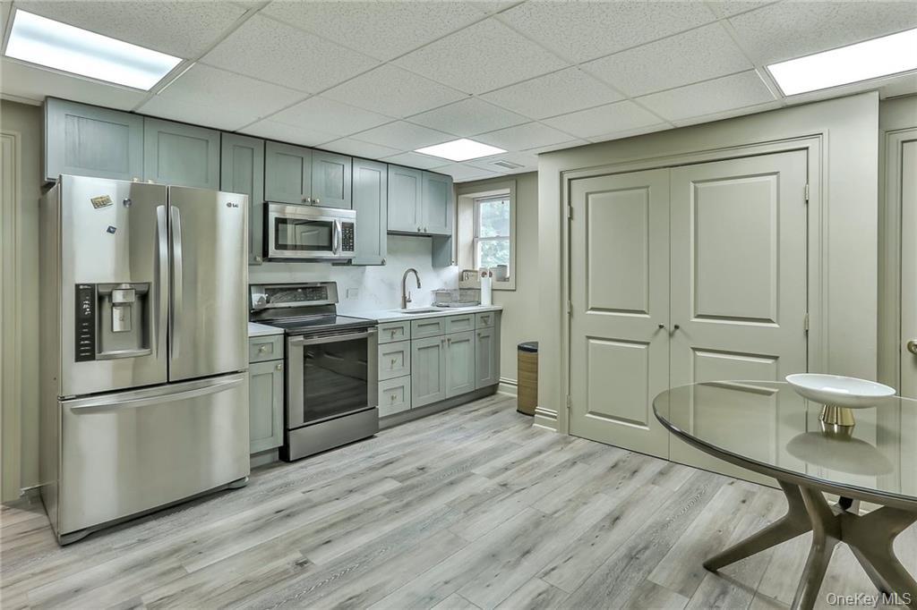 433 New Rochelle Road Bronxville, NY 10708 - Photo 27 of 41 a kitchen with stainless steel appliances a refrigerator sink and microwave