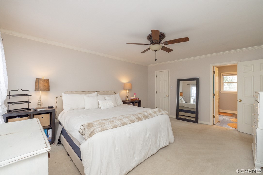 15205 Powell Grove Road Midlothian, VA 23112 - Photo 34 of 47 a bedroom with a bed and a chandelier