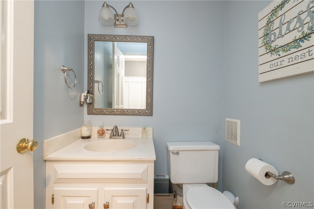 15205 Powell Grove Road Midlothian, VA 23112 - Photo 8 of 47 a bathroom with a sink a toilet and mirror