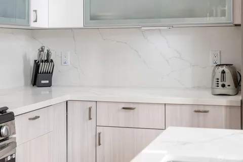 a kitchen with a white cabinets and a white counter