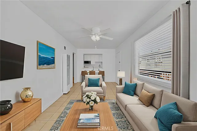 a living room with furniture a rug and a window