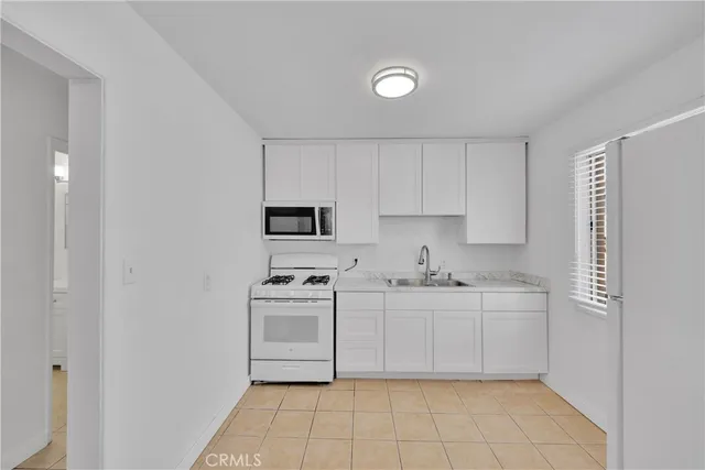 a kitchen with stainless steel appliances a sink and cabinets