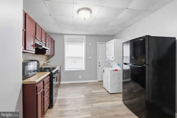 a kitchen with a refrigerator and a sink