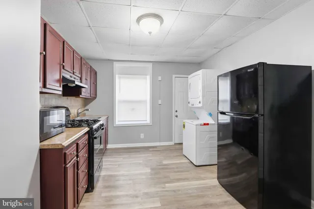 a kitchen with a refrigerator and a sink