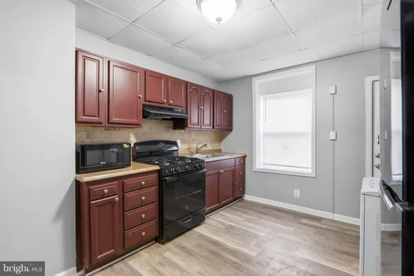 a kitchen with stainless steel appliances granite countertop a stove sink and cabinets