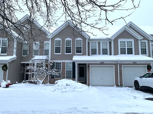 a front view of a house with yard and seating space
