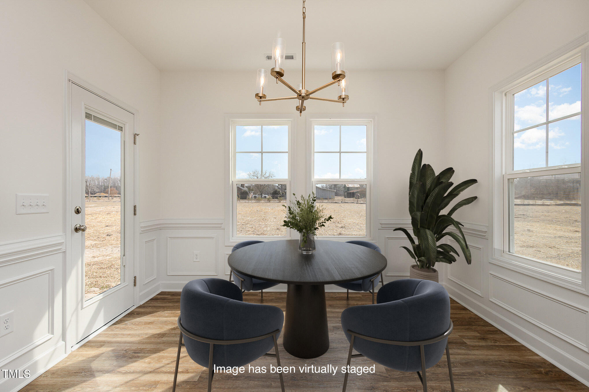 231 Trescott Street Smithfield, NC 27577 - Photo 13 of 28 a dining room with chandelier fan and wooden floor