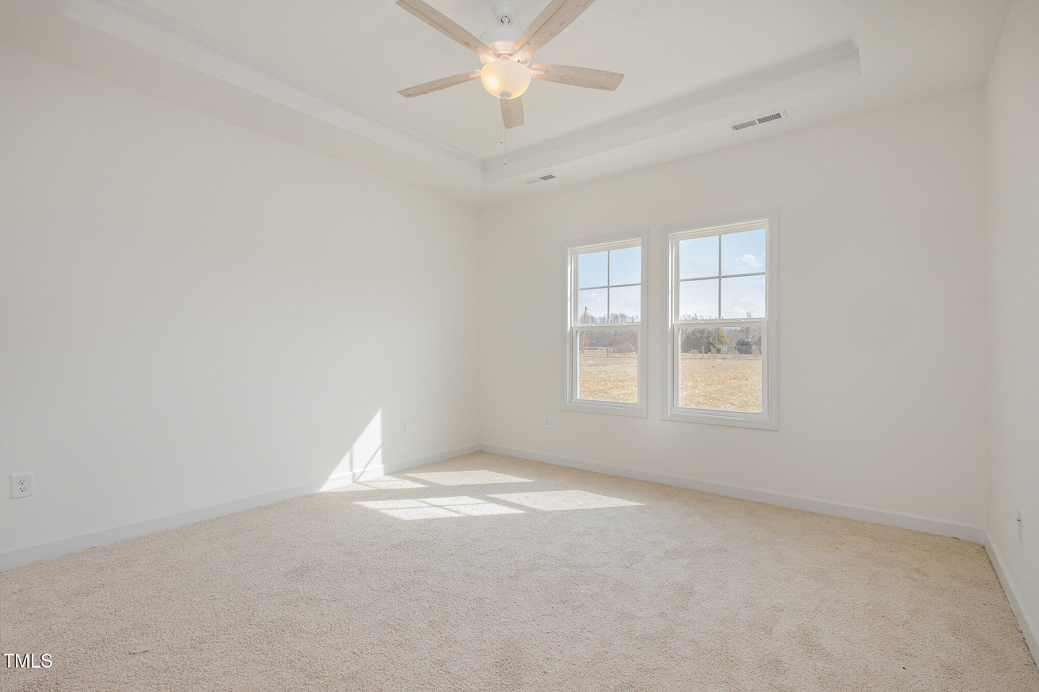 231 Trescott Street Smithfield, NC 27577 - Photo 16 of 28 an empty room with a window and a fan