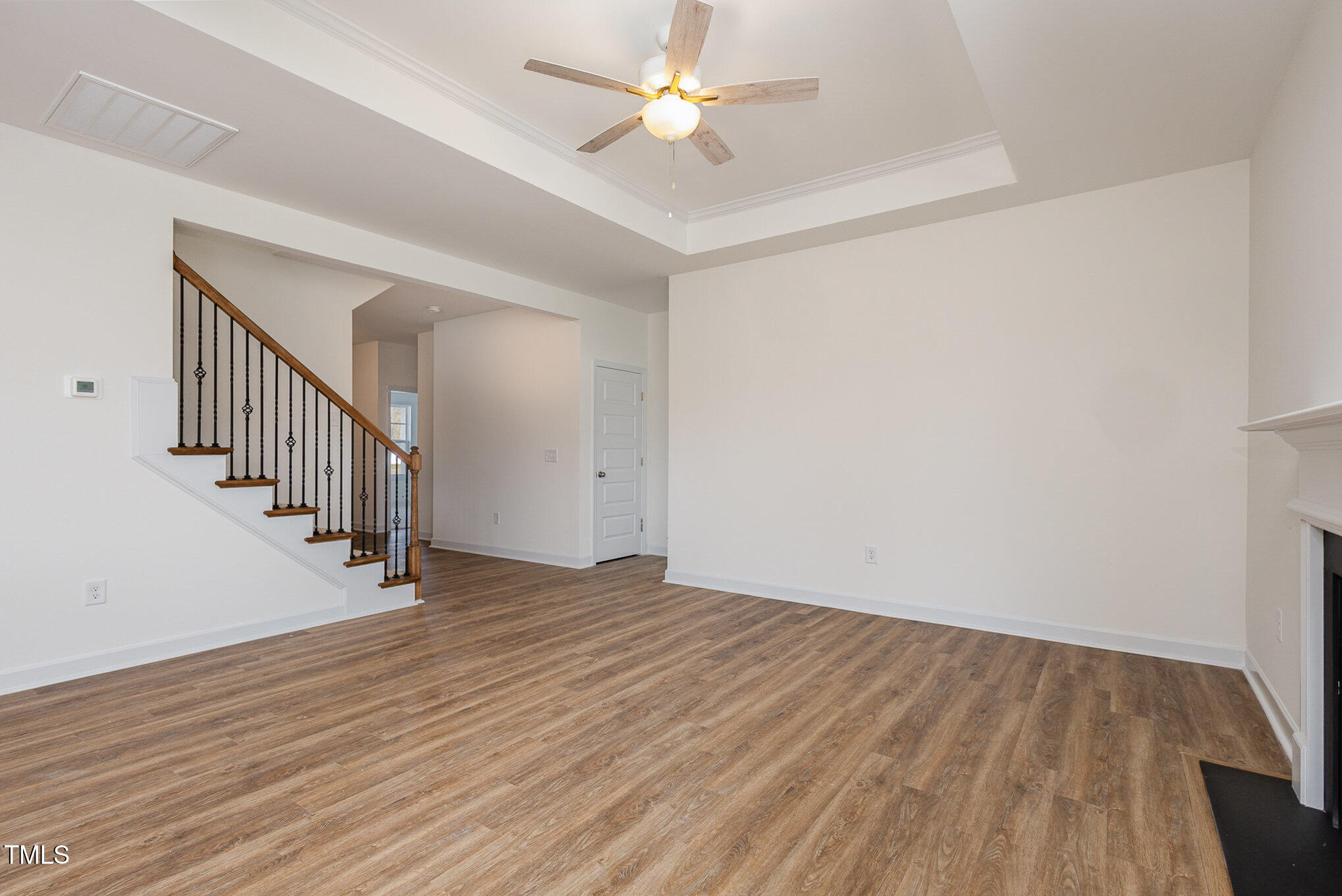 231 Trescott Street Smithfield, NC 27577 - Photo 7 of 28 wooden floor in a hall with an entryway and a chandelier