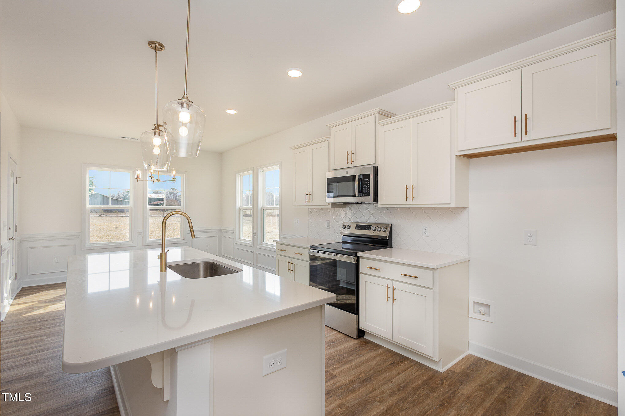 231 Trescott Street Smithfield, NC 27577 - Photo 9 of 28 a kitchen with kitchen island white cabinets and appliances