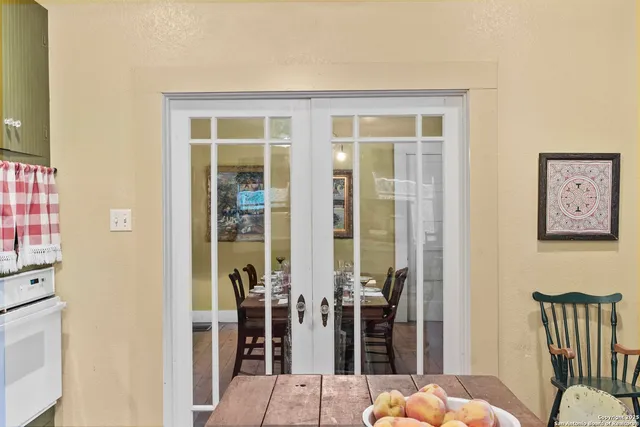a bedroom with a balcony a bed and large window