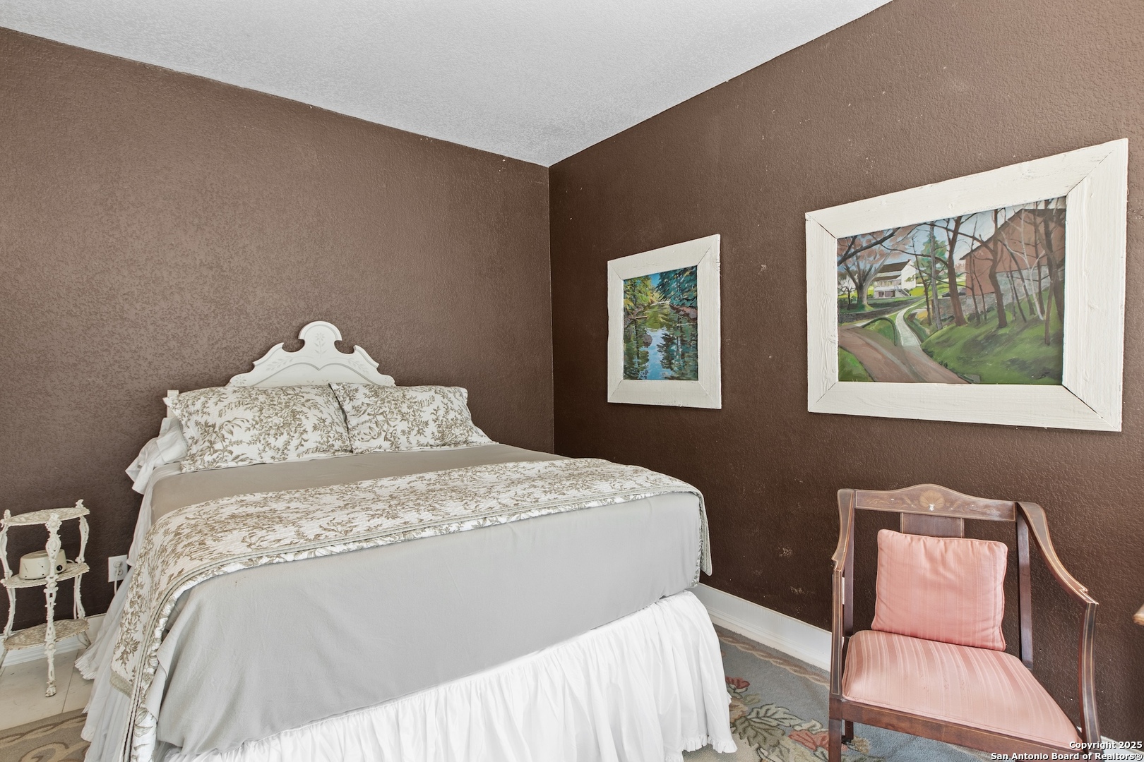 211 Riverside Drive West Llano, TX 78643 - Photo 26 of 74 a bedroom with a bed and a painting on the wall