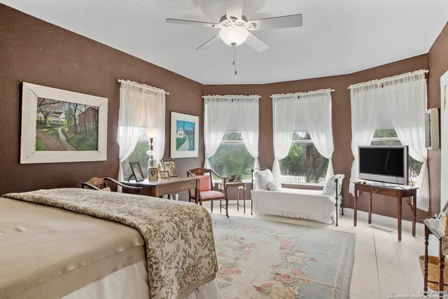 a living room with furniture fireplace and a large window