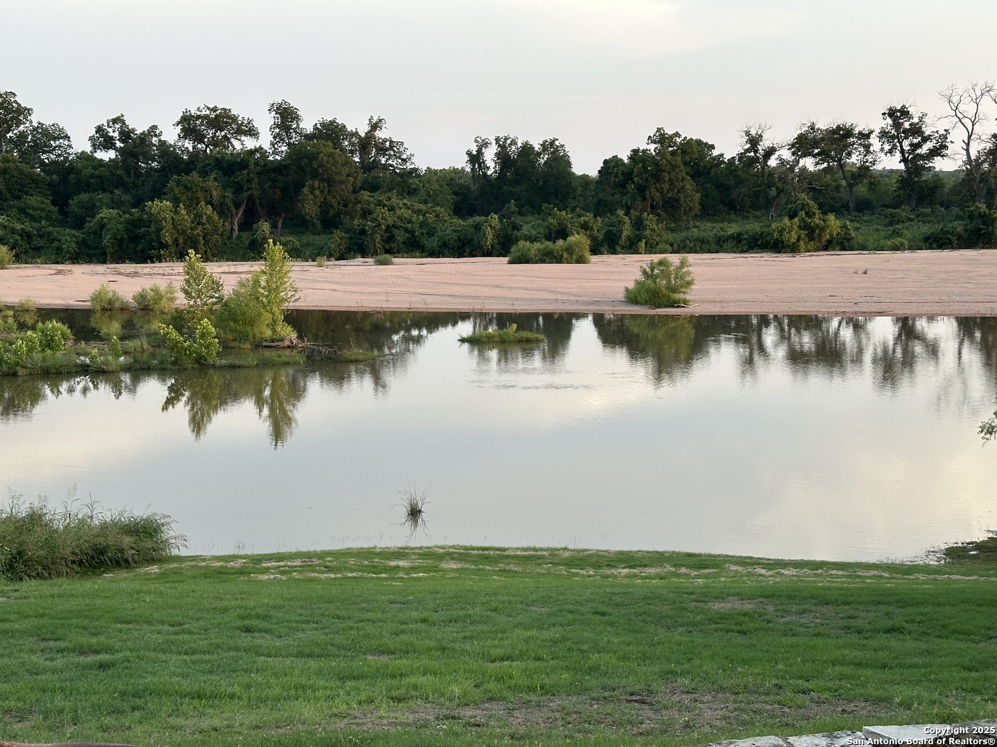 211 Riverside Drive West Llano, TX 78643 - Photo 4 of 74 a view of a lake from a yard
