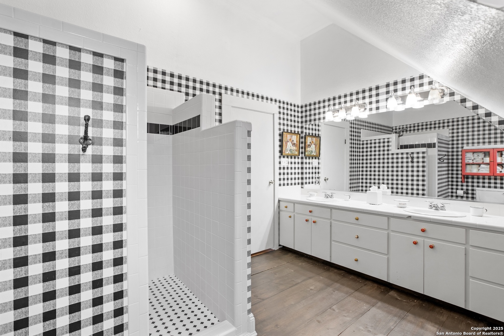 211 Riverside Drive West Llano, TX 78643 - Photo 44 of 74 a bathroom with a double vanity sink a mirror and a shower